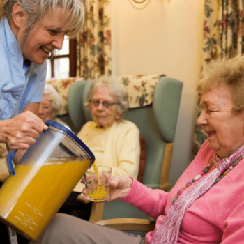 Serving Care Home Resident Orange Juice from Oranka Juice Solutions